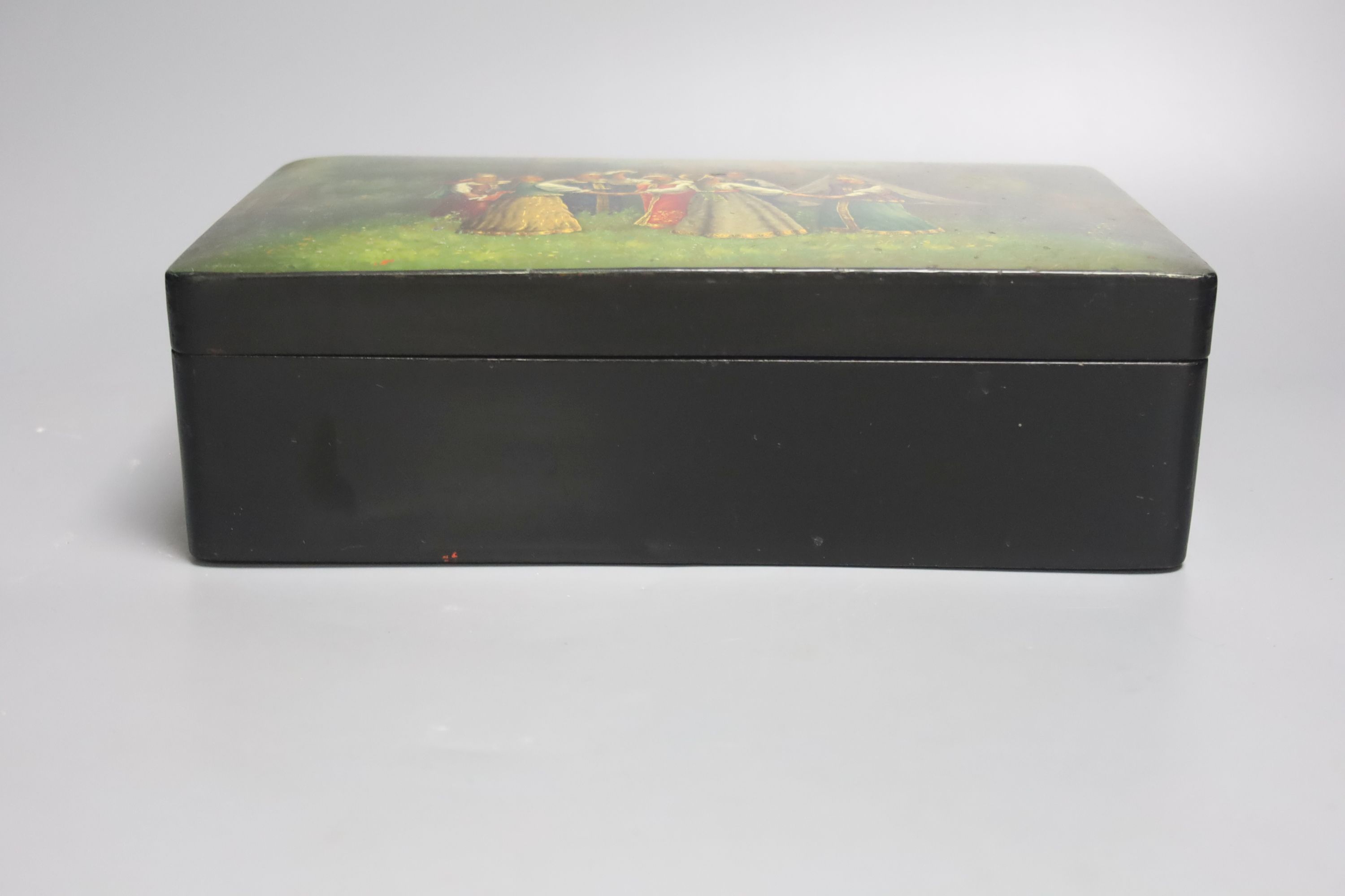 A 19th century Russian lacquer box, decorated with dancers to the cover, and signed lower left, 29 x 18cm